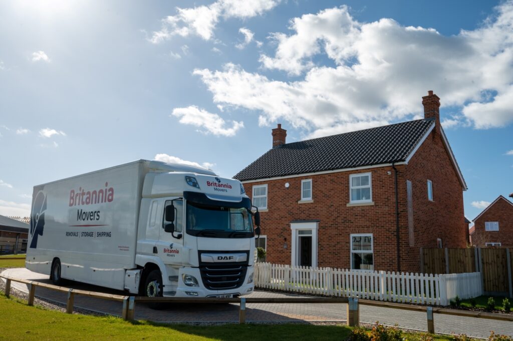 Britannia Movers truck outside new home on sunny day