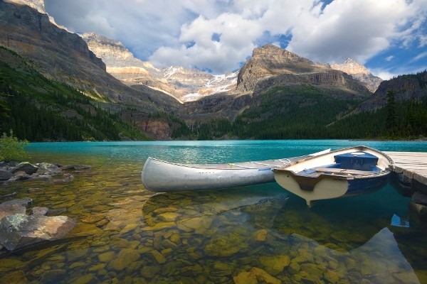 Aluminum canoe and a boat on a mountain lake