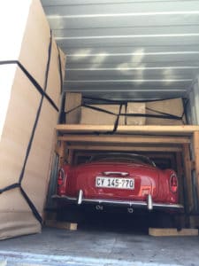 classic car loaded into shipping container